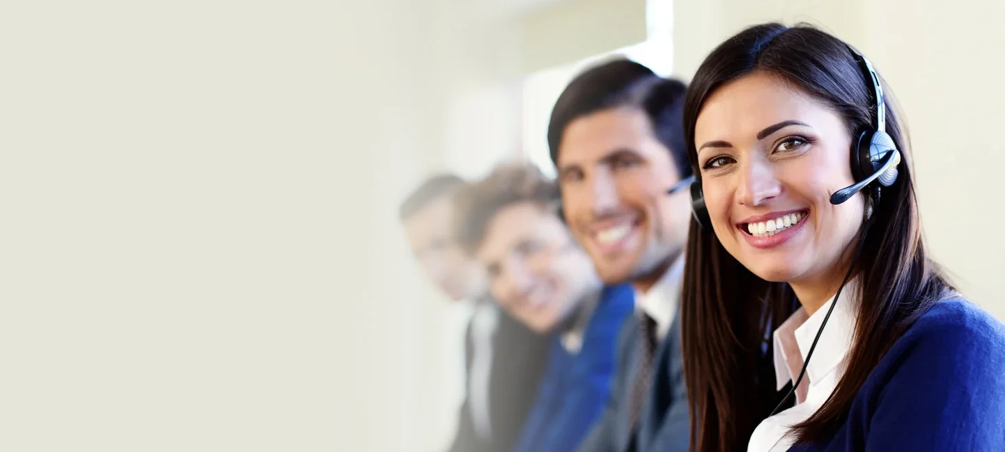 A group of people chatting and smiling in a call center.