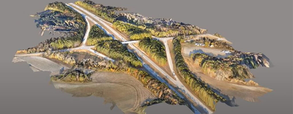 A 3D model of a landscape featuring intersecting roads, greenery, and surrounding fields from an elevated perspective—ideal for civil infrastructure planning or multidiscipline design collaborations.