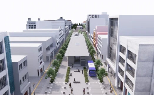 An aerial view of a city street reveals a SYNCHRO-designed modern bus stop at the center, nestled among tall buildings. Trees line the sidewalks as people walk by, illustrating urban vibrancy in this living case study of efficient public space integration. An aerial view of a city street reveals a SYNCHRO-designed modern bus stop at the center, nestled among tall buildings. Trees line the sidewalks as people walk by, illustrating urban vibrancy in this living case study of efficient public space integration.