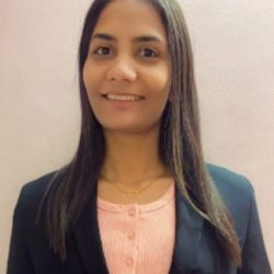 A woman with long brown hair, wearing a pink shirt and a black blazer, smiles at the camera against a plain background, embodying the precision of Highway Design. A woman with long brown hair, wearing a pink shirt and a black blazer, smiles at the camera against a plain background, embodying the precision of Highway Design.