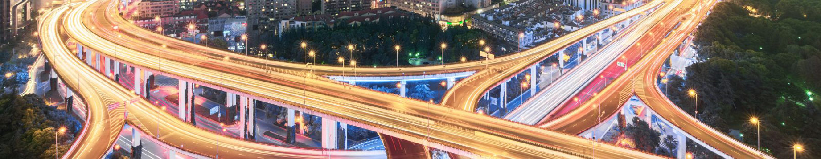 an interstate that is lit by the cars driving over it at night