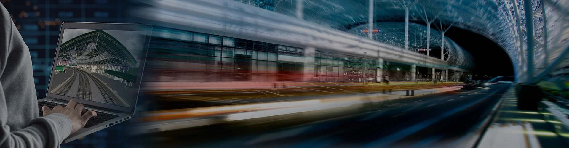 A person uses a laptop with an image of a transit station, likely created in MicroStation. In the foreground, there are blurred trails of lights from vehicles in motion. The background showcases the structure of a modern transit terminal, highlighting advanced infrastructure design.